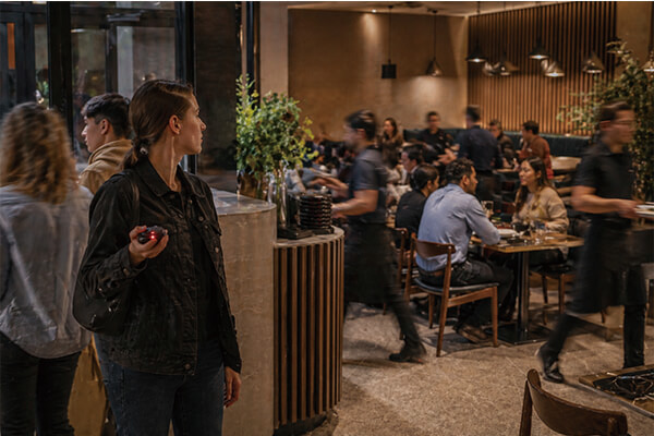 A busy restaurant with staff and customers